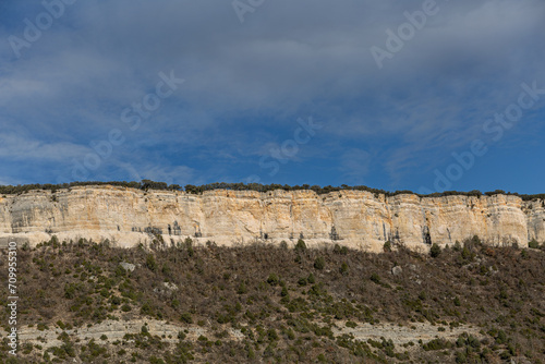 Vertical rock walls  forests and blue sky. Puentedey  Las Merindades Region  Burgos  Spain.