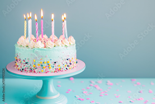 colourful birthday cake with candles on a pastel background 