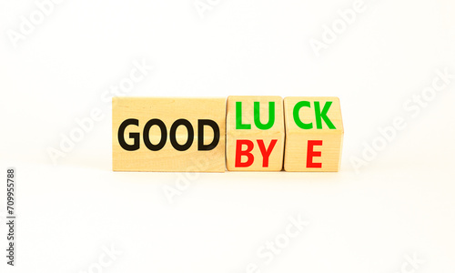 Good luck or goodbye symbol. Concept words Good luck or Goodbye on beautiful wooden blocks. Beautiful white table white background. Business, motivational good luck concept. Copy space.