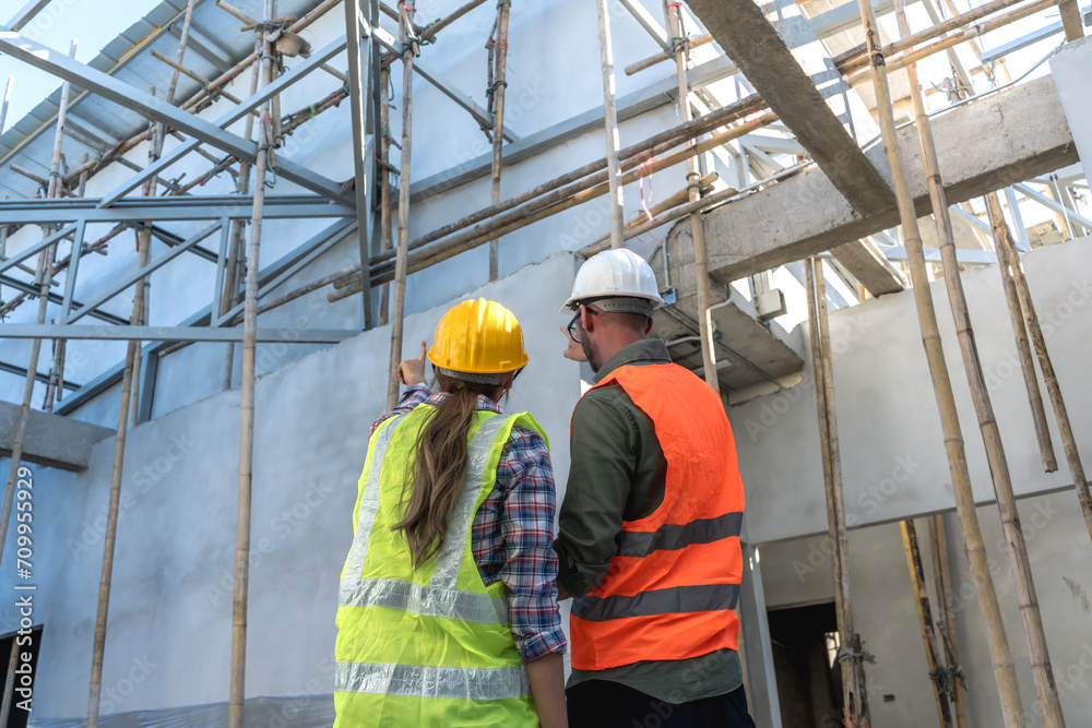 construction worker man and woman with helmet working on construction site construction worker man and woman with helmet working on construction site