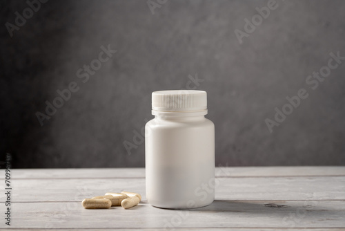 Antibiotics pills in white plastic bottle. Capsules, collagen, vitamins, pain killers or drugs
