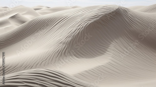 the desert in a crystal-clear photograph, showcasing the intricate patterns of wind-sculpted sand against the backdrop of a clear sky. © Khan