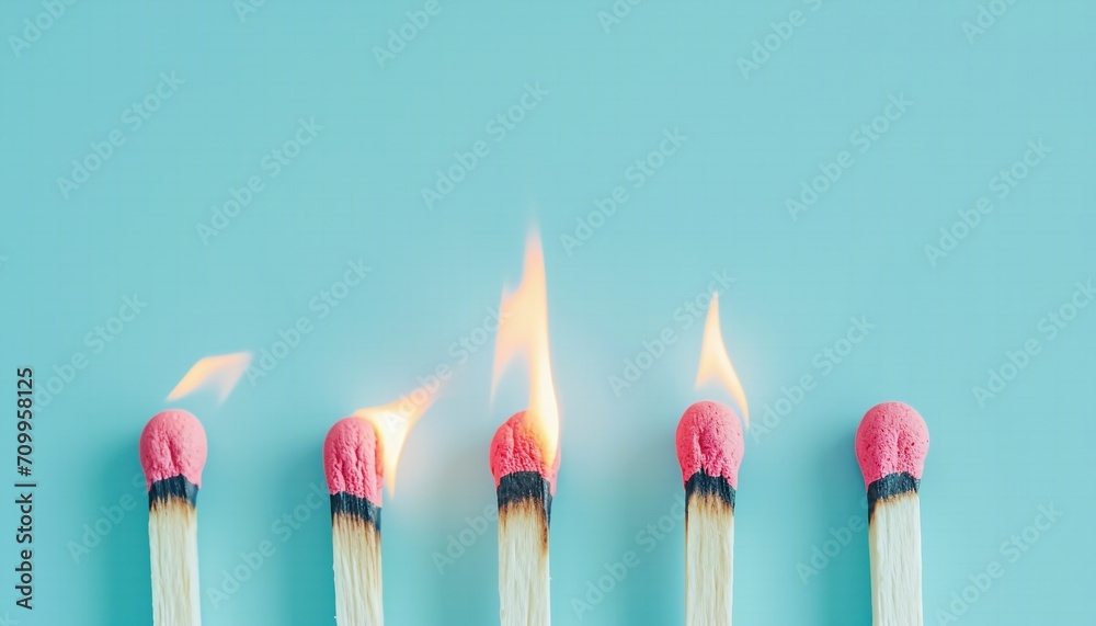 Matches burning on a light blue background.Flame and fire photography Matches burning on a light blue background.Flame and fire photography