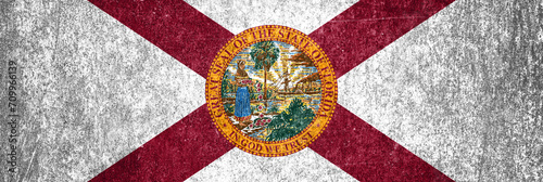 Close-up of the grunge Florida State flag. Dirty Florida State flag on a metal surface. photo