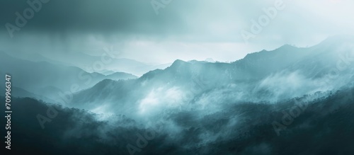 Abstract, foggy landscape with mountains and a dark background during rainy nature.