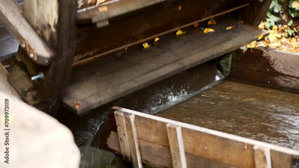 Close-up of the water turning the water mill wheel. Close-up of the water turning the water mill wheel.