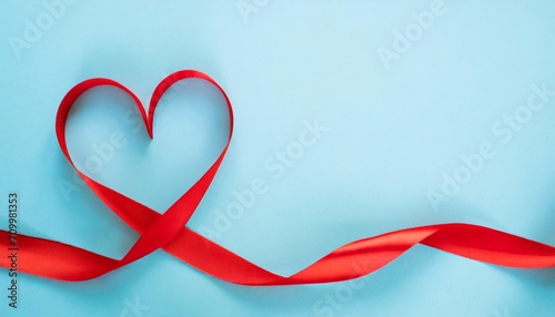 valentine day card or banner red heart of ribbon on blue background flat lay