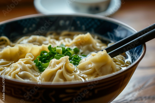 A detailed shot capturing the intricate textures and flavors of Chinese wonton noodle soup in a bowl photo