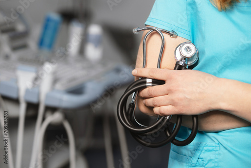 Doctor holds his stethoscope to insinuate that it's time for a check up, professional emergency healthcare assistance service concept. Professional doctor ready to listen lungs or heart. photo