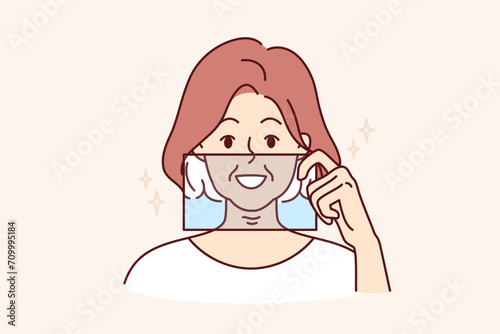 Woman demonstrates snow-white smile by applying glass to face and presenting result after whitening procedure at dentist. Young girl with beautiful smile represents own image in old age