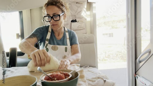 Adult woman lady housewife baker wearing apron kneading flour on kitchen table. Baking pastry concept cooking biscuit cake making bakery making homemade pizza at home photo