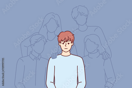 Man sits among phnom friends helping to cope with problems, as metaphor for loneliness and lack of social connections. Guy feels insecure due to loneliness causing stress and depression