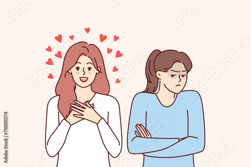 Woman envies blogger gets likes on social networks and becomes popular on internet or dating apps. Girl smiles standing among hearts, near female friend who envies and needs support