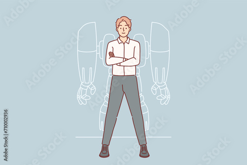 Businessman with robot exoskeleton stands with arms crossed and proud synergy with modern technology