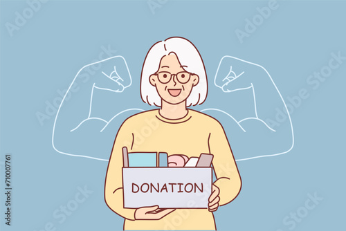 Grandmother holds donation box, wanting to help needy people in trouble, stands near phantom biceps