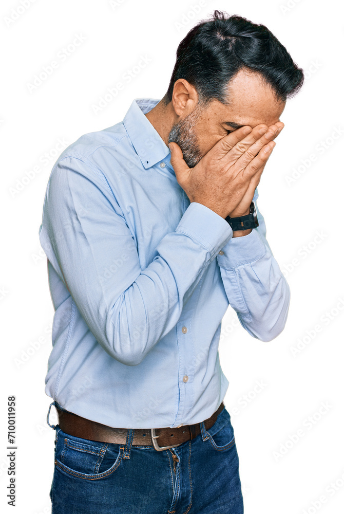 Middle aged man with beard wearing business shirt with sad expression covering face with hands while crying. depression concept. Middle aged man with beard wearing business shirt with sad expression covering face with hands while crying. depression concept.