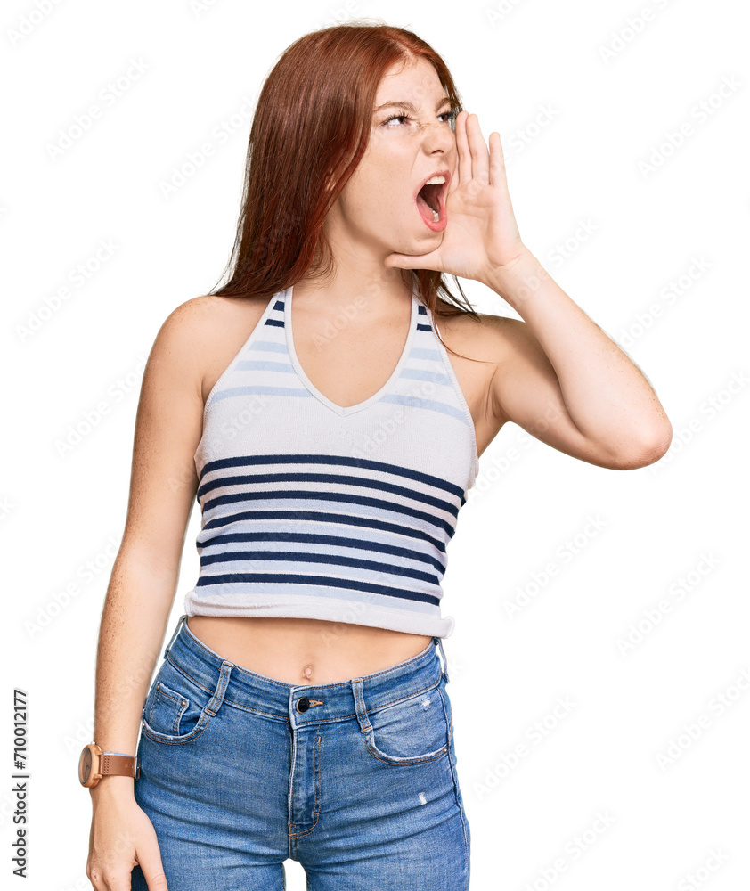 Young read head woman wearing casual clothes shouting and screaming loud to side with hand on mouth. communication concept.