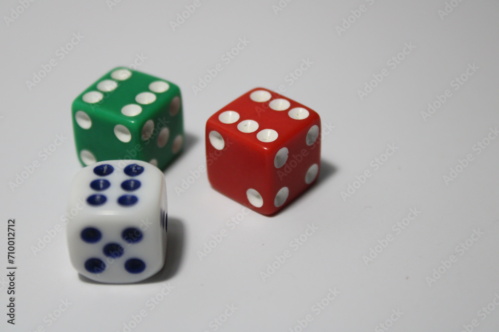 Close up of three different colored dice red, green, and white isolated on white background Close up of three different colored dice red, green, and white isolated on white background