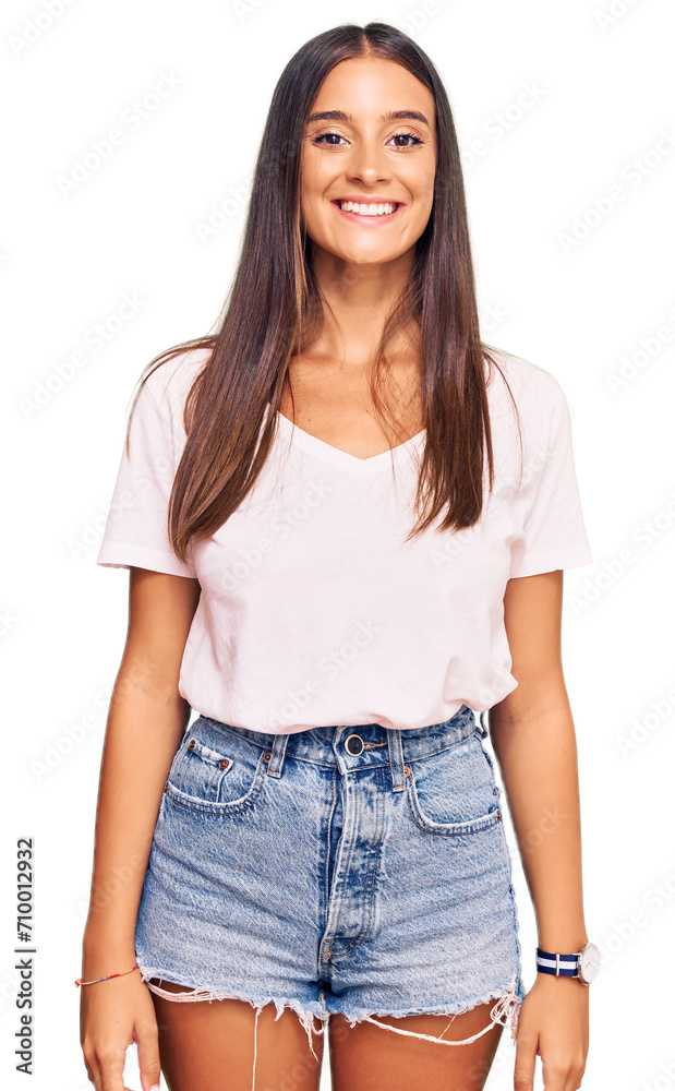 Fototapeta premium Young hispanic woman wearing casual white tshirt with a happy and cool smile on face. lucky person.