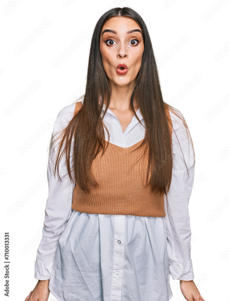Young beautiful woman wearing casual white shirt scared and amazed with open mouth for surprise, disbelief face Young beautiful woman wearing casual white shirt scared and amazed with open mouth for surprise, disbelief face
