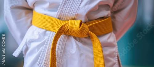 Yellow belt in Aikido, wearing white kimono.