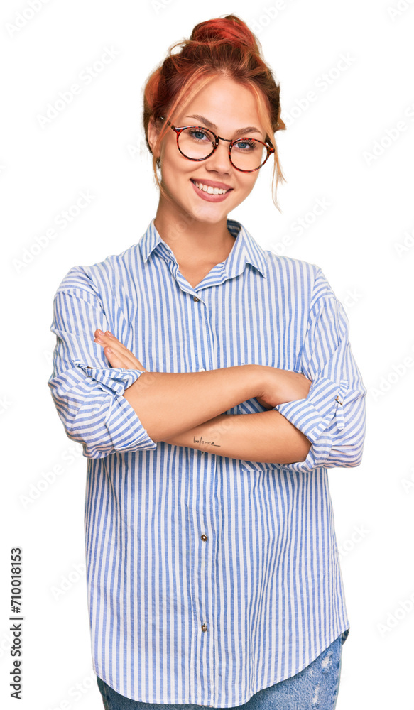 Young redhead woman wearing casual clothes and glasses happy face smiling with crossed arms looking at the camera. positive person. Young redhead woman wearing casual clothes and glasses happy face smiling with crossed arms looking at the camera. positive person.
