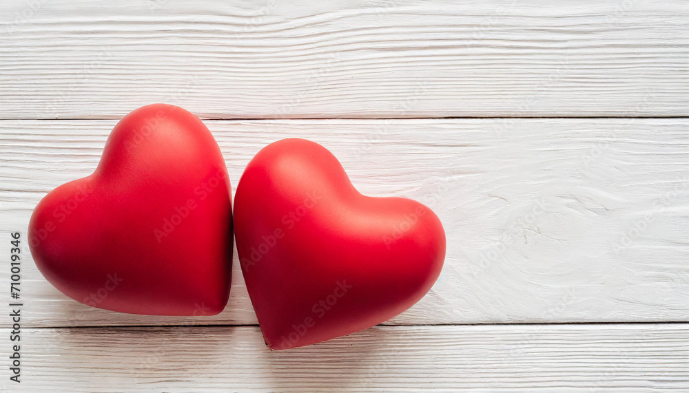 Valentines day background with two red hearts on white wooden table Valentines day background with two red hearts on white wooden table