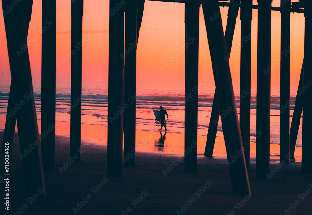 Surfer Under Pismo Pier Sunset