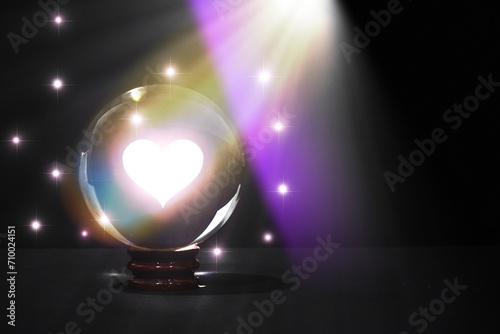 Heart Symbol Inside Crystal Ball with Twinkling Stars : A crystal ball reveals a bright heart symbol surrounded by twinkling stars, creating a romantic and mystical atmosphere.