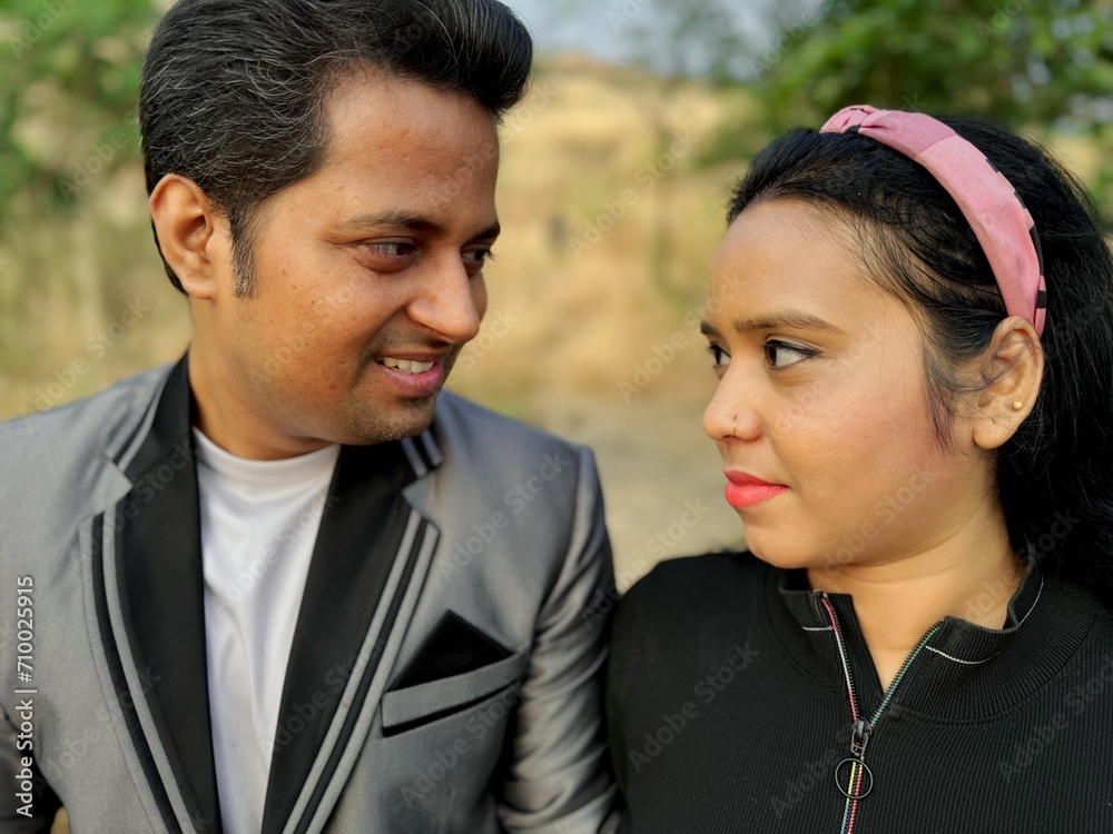 Affectionate couple sharing Love a looking each other with natural backdrop Affectionate couple sharing Love a looking each other with natural backdrop