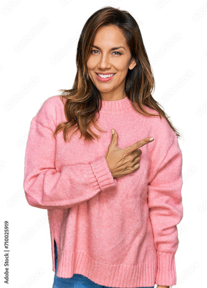 Young hispanic woman wearing casual clothes cheerful with a smile on face pointing with hand and finger up to the side with happy and natural expression Young hispanic woman wearing casual clothes cheerful with a smile on face pointing with hand and finger up to the side with happy and natural expression