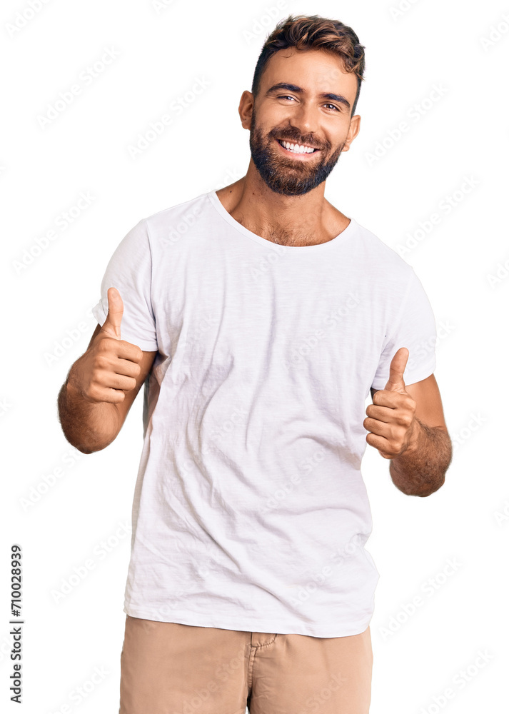 Young hispanic man wearing casual white tshirt success sign doing positive gesture with hand, thumbs up smiling and happy. cheerful expression and winner gesture. Young hispanic man wearing casual white tshirt success sign doing positive gesture with hand, thumbs up smiling and happy. cheerful expression and winner gesture.