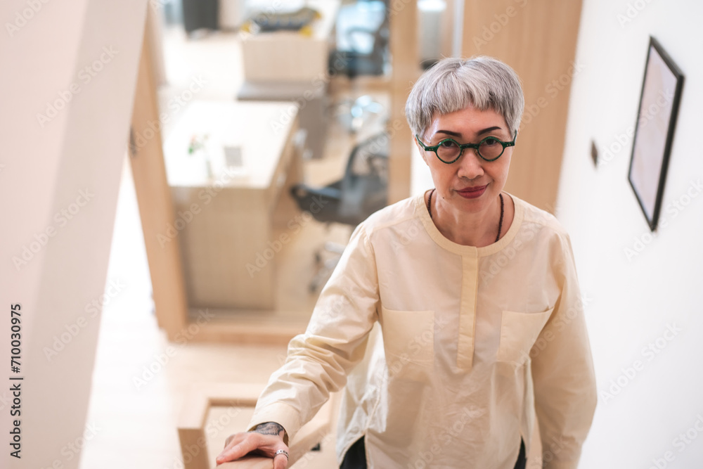 A Portrait of leadership, confidence and fashionable Senior business woman, entrepreneur or executive for career. Mature CEO older lady with positive energy standing in her modern office or workplace.