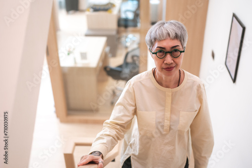 A Portrait of leadership, confidence and fashionable Senior business woman, entrepreneur or executive for career. Mature CEO older lady with positive energy standing in her modern office or workplace.