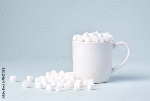 mug with white marshmallows on table on a white surface