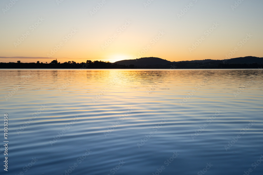 Morning sunrise glow across bay Morning sunrise glow across bay