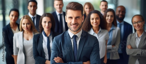 Confident business team  leader at forefront  looking at camera  smiles.