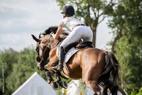 Equestrian Sports photo themed: Woman Jockey, Horse jumping, Show Jumping, Horse riding. 