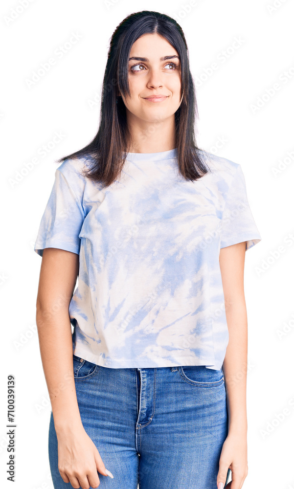 Fototapeta premium Young beautiful girl wearing casual t shirt smiling looking to the side and staring away thinking.