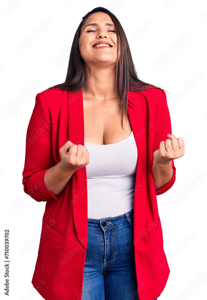 Young beautiful brunette woman wearing elegant clothes excited for success with arms raised and eyes closed celebrating victory smiling. winner concept. Young beautiful brunette woman wearing elegant clothes excited for success with arms raised and eyes closed celebrating victory smiling. winner concept.