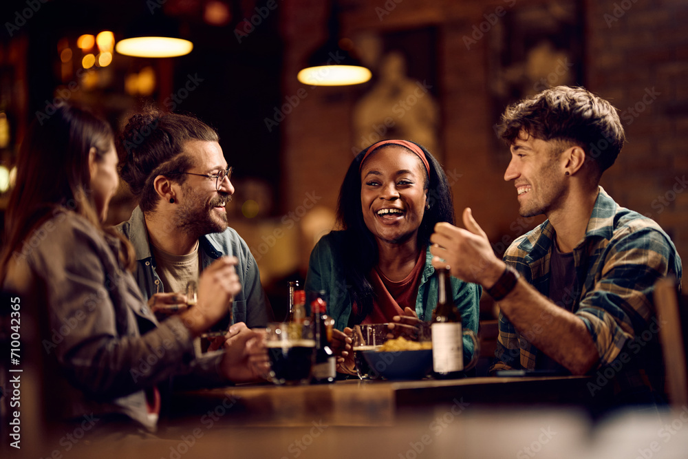 Cheerful black woman having fun with her friends in bar. Cheerful black woman having fun with her friends in bar.