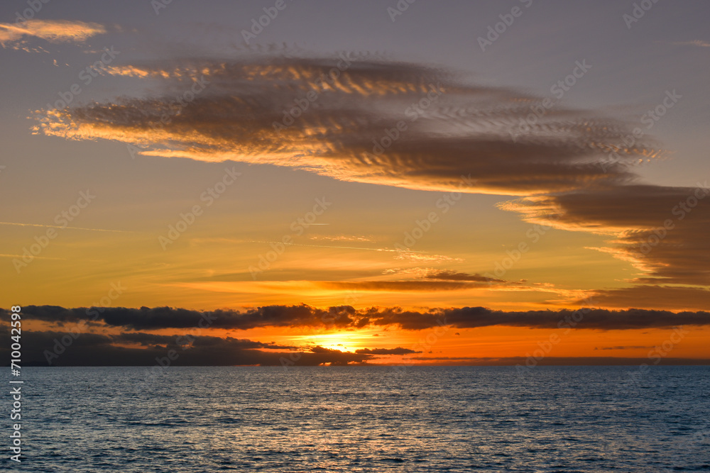 Fototapeta premium Sunset sky over the sea, panorama with cloud colored sky over blue sea