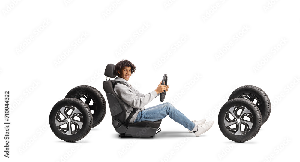 African american young man in a car seat on four tires African american young man in a car seat on four tires