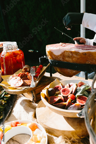 Rich bright Italian aperitif at a luxury beautiful wedding in a luxurious villa in Italy, Tuscany. Typical Italian appetizers, cheeses, ham, tomatoes and berries on the table