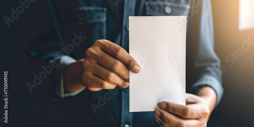 Latin American person hands showing white card