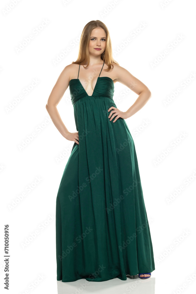 Full body front view portrait of elegant lovely blond lady  posing isolated on white background in green long dress