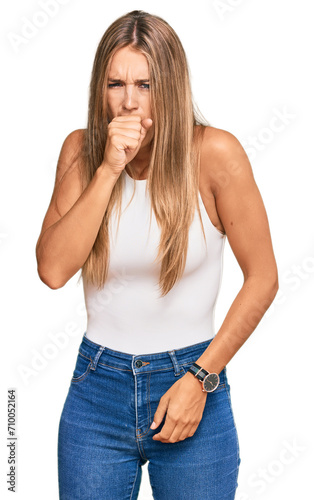 Young blonde woman wearing casual style with sleeveless shirt feeling unwell and coughing as symptom for cold or bronchitis. health care concept.