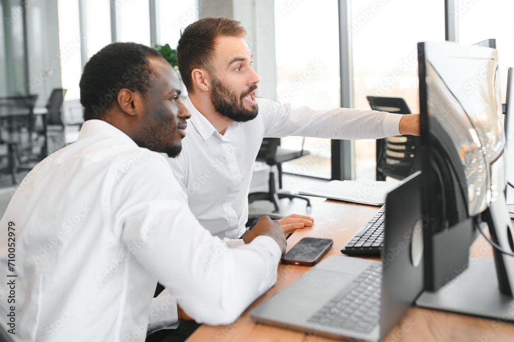 Two diverse crypto traders brokers stock exchange market investors discussing trading charts research reports growth using pc computer looking at screen analyzing invest strategy, financial risks Two diverse crypto traders brokers stock exchange market investors discussing trading charts research reports growth using pc computer looking at screen analyzing invest strategy, financial risks