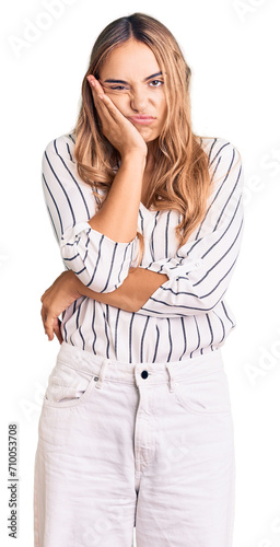 Young beautiful blonde woman wearing casual clothes thinking looking tired and bored with depression problems with crossed arms. photo