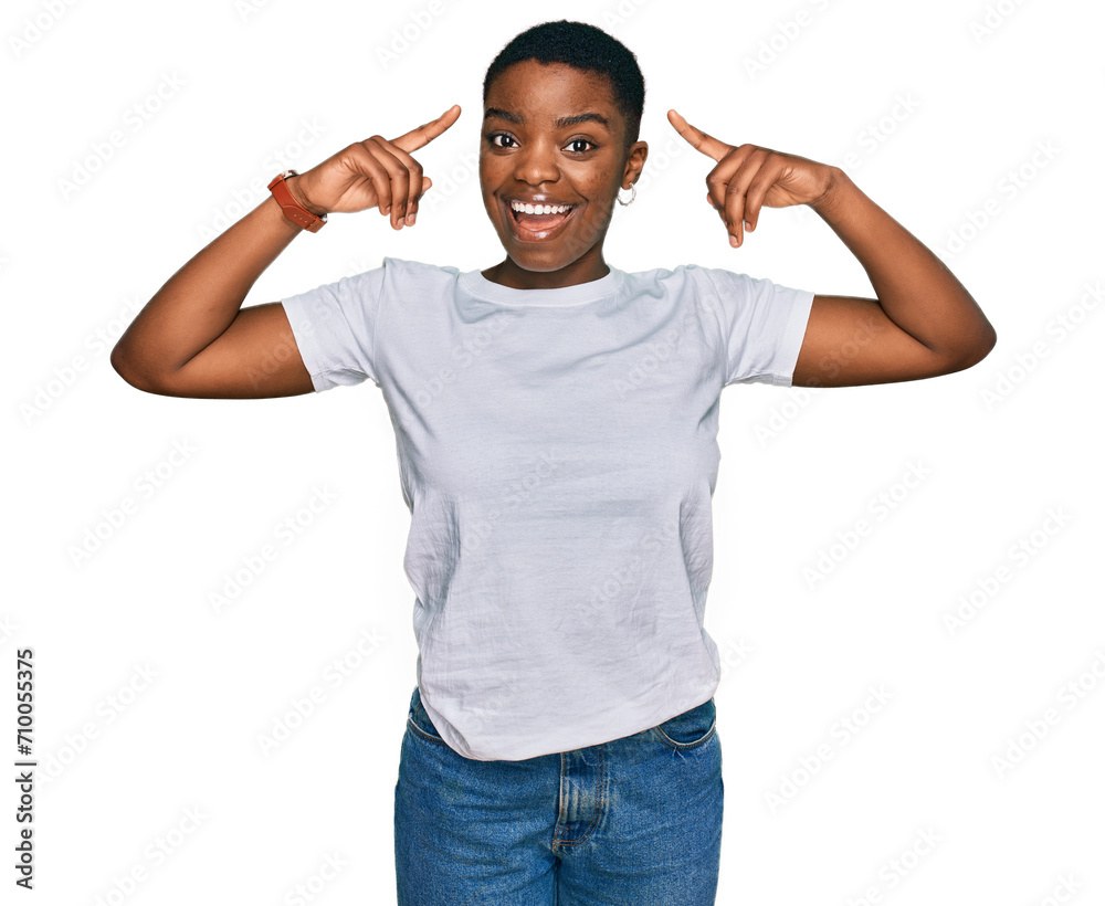 Young african american woman wearing casual white t shirt smiling pointing to head with both hands finger, great idea or thought, good memory Young african american woman wearing casual white t shirt smiling pointing to head with both hands finger, great idea or thought, good memory